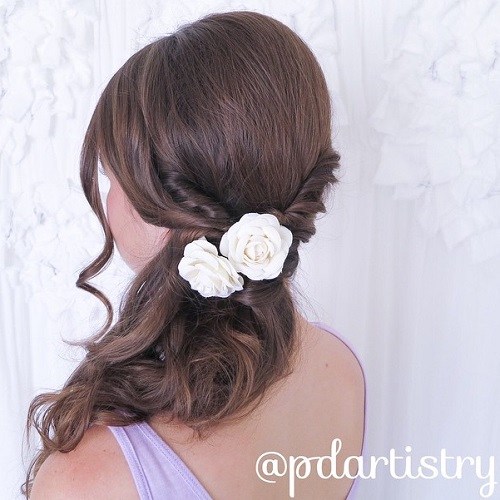 Curly side ponytail with twists and flower