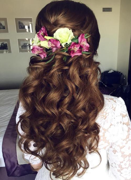 curly wedding half updo with flowers