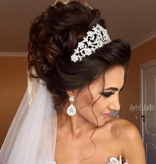 curly wedding updo with tiara and veil