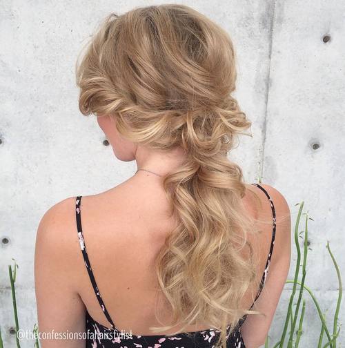 Blonde wavy low ponytail with side twists