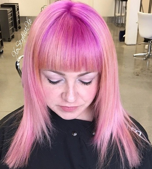 Medium pastel pink hair with straight bangs