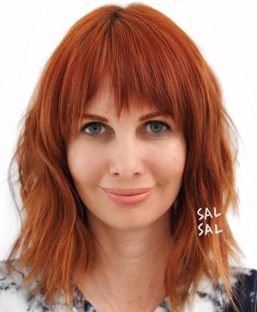 Shaggy red hairstyle with bangs
