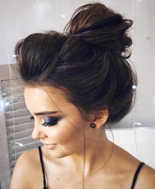 Voluminous messy bun with teased roots