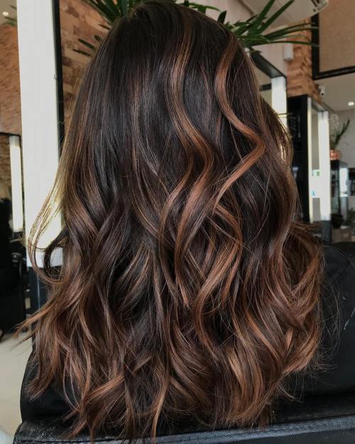 Wavy brown hair with caramel highlights