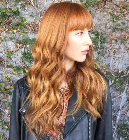Copper red wavy hair with blunt bangs