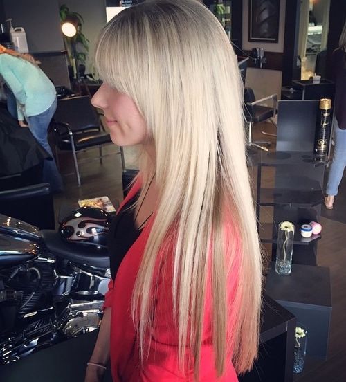 Long layered haircut with arched bangs