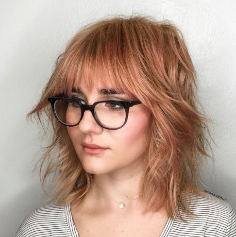 Strawberry blonde shag with bangs