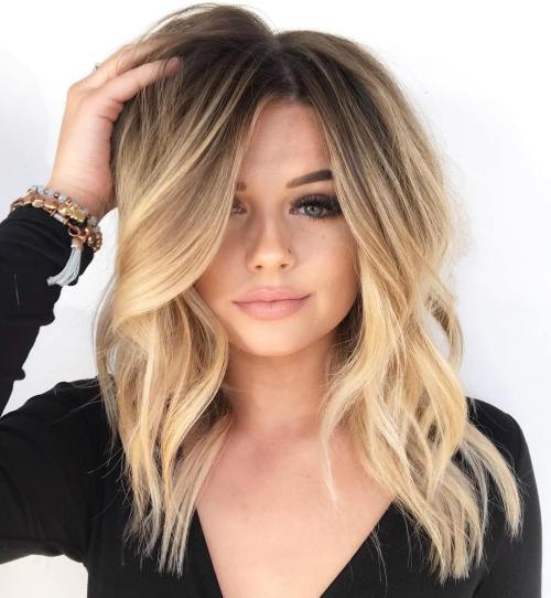 Medium layered hairstyle with off centre parting