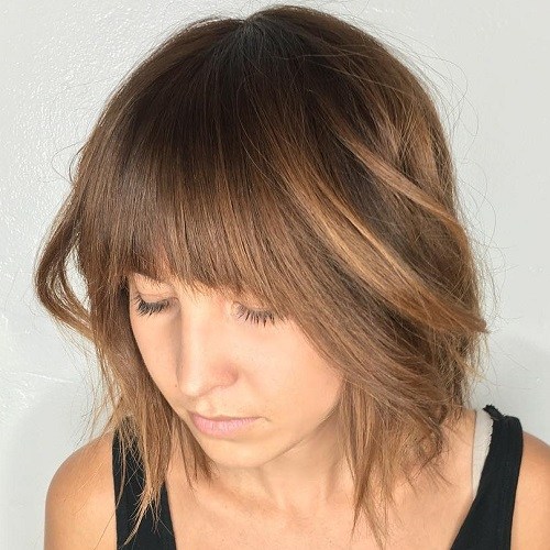 Medium shaggy hairstyle with arched bangs