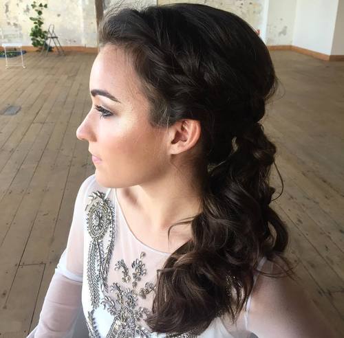 Side curly ponytail with a loose braid