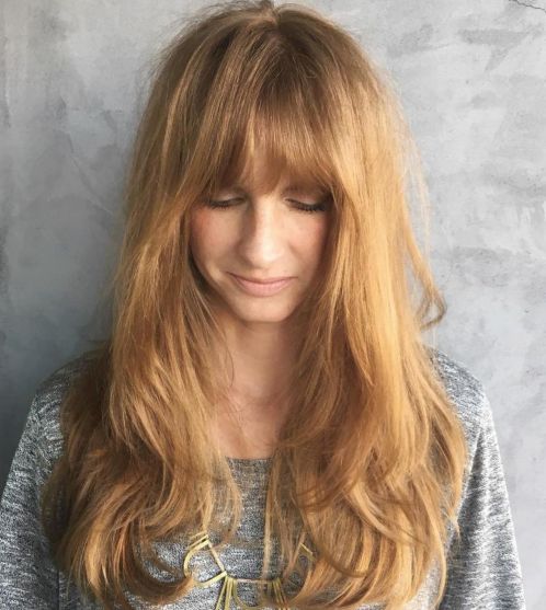 Long strawberry blonde hairstyle with bangs