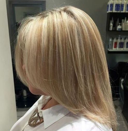 Medium blonde hairstyle with subtle highlights